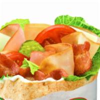 Club · Our Classic Club pita comes with Turkey, Ham, Bacon, Romaine, Tomatoes, Pickles, Provolone, ...