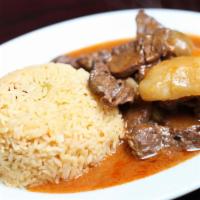 Carne Guisada · Beef stew with rice and beans.