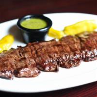 Entrana · Grilled skirt steak with chimichurri sauce, rice, and salad.