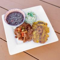 Ropa Vieja con Tostones · Wine braised inside skirt steak with roasted red peppers, olives, tostones, cilantro lime ri...
