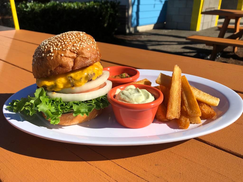 Cheeseburger and Fries · Dos Hermanos bakery bun, beef Patty, American cheese, lettuce, onion, tomato, pickles, burger sauce. Served with Yuca fries and aioli.