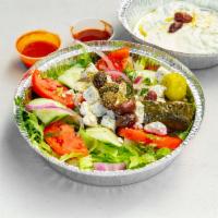 Greek Salad · Tomatoes, onions, cucumbers, olives, feta, dolmades, and dressing of your choice. Add meat f...