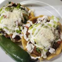 11. Sopes · 2 pieces. Served with your choice of meat.