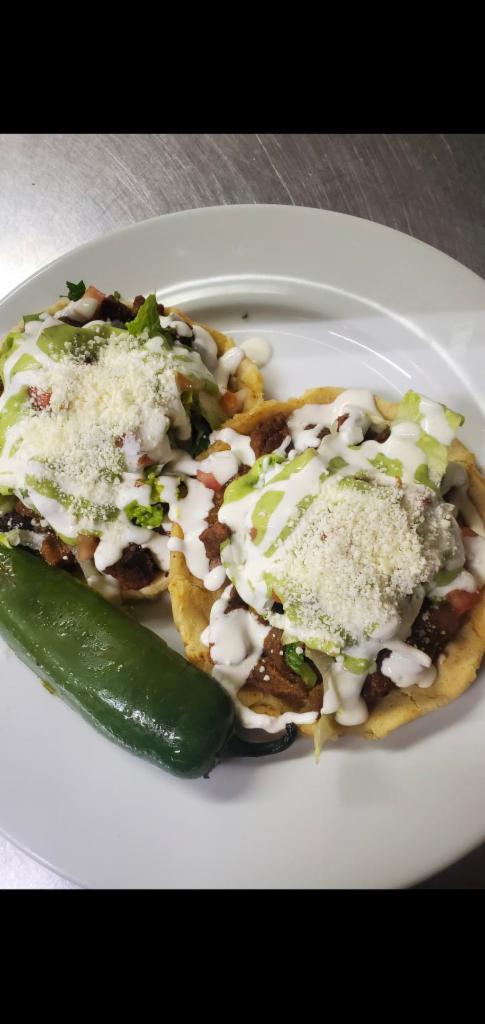 11. Sopes · 2 pieces. Served with your choice of meat.