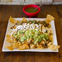 Nachos · Steak, chorizo or chicken. Corn tortilla chips baked with fried beans, cheddar and Monterey ...