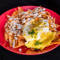 Chilaquiles · Corn tortilla chips shimmered with sauce. Served with sunny side up eggs, cheese, sour cream...