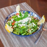 Laila Salad · Syrian garden salad, feta cheese, olive oil, and lemon juice.