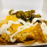 Tostielotes · Tostitos, nacho cheese, corn, cream, and jalapeno.