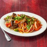 Fajitas de Carne · Served with red and green peppers, white onions and fresh cilantro on top.