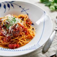 SPAGHETTI & MEATBALLS · A classic dish with freshly peeled tomatoes, herbs, olive oil and garlic.