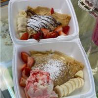 Crepe with Fruit · Crepe with strawberry and banana, topped with Nutella and whip cream.
