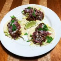 Tacos  · 3 per order. Our house smoked chicken, pork, or brisket in tinga sauce with napa, pickled re...