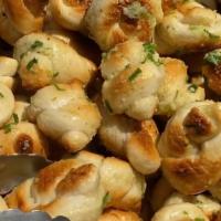 5 Piece Garlic Knots · Soft fluffy baked bread knots with our signature garlic sauce