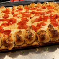 Roni Cup Garlic Knot Pie · POPULAR!!

Fluffy garlic knot bread crust sicilian pie loaded with small cup style pepperoni 