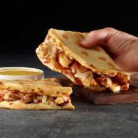 GRILLED BBQ CHICKEN AND BACON PAPADIA · Flatbread-style sandwich with BBQ sauce, cheese, grilled chicken, bacon and onions. Served w...