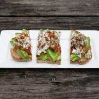 Avocado Toast · On grilled sourdough with roasted tomatoes and feta.
