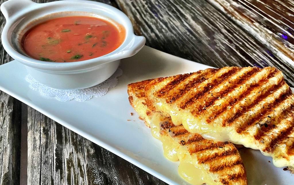Grilled Cheese & Tomato Soup · coastal cheddar, raclette on challah & homemade tomato soup made w/ sherry wine and heavy cream.