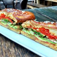 The Scoutmaster · fresh tomato, red onions, avocado, arugula, pickle chips, piquillo peppers and chipotle mayo...