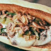 Brisket CheeseSteak · 14-hour smoked Brisket, Thinly sliced, grilled with green peppers, poblano peppers, mushroom...