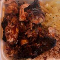 Jerk Chicken · Served with rice & beans and cabbage.