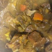 Curry Goat · With rice & beans and cabbage 