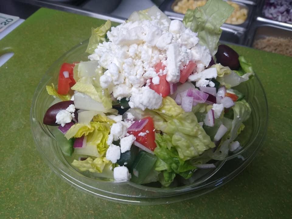 Greek salad  · Romaine lettuce, tomatoes, cucumber, red onion, imported feta cheese, kalamata olives and Dijon dressing.