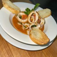 Sauteed Calamari  · Sauteed calamari with garlic, butter, white wine, and marinara sauce 
Served with toasted ba...