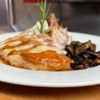 Poulet Roti aux Champignons · Roasted chicken au jus with wild mushroom, mashed potatoes and truffle oil.