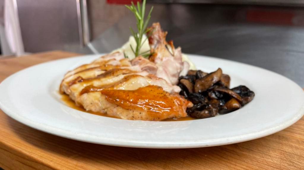 Poulet Roti aux Champignons · Roasted chicken au jus with wild mushroom, mashed potatoes and truffle oil.