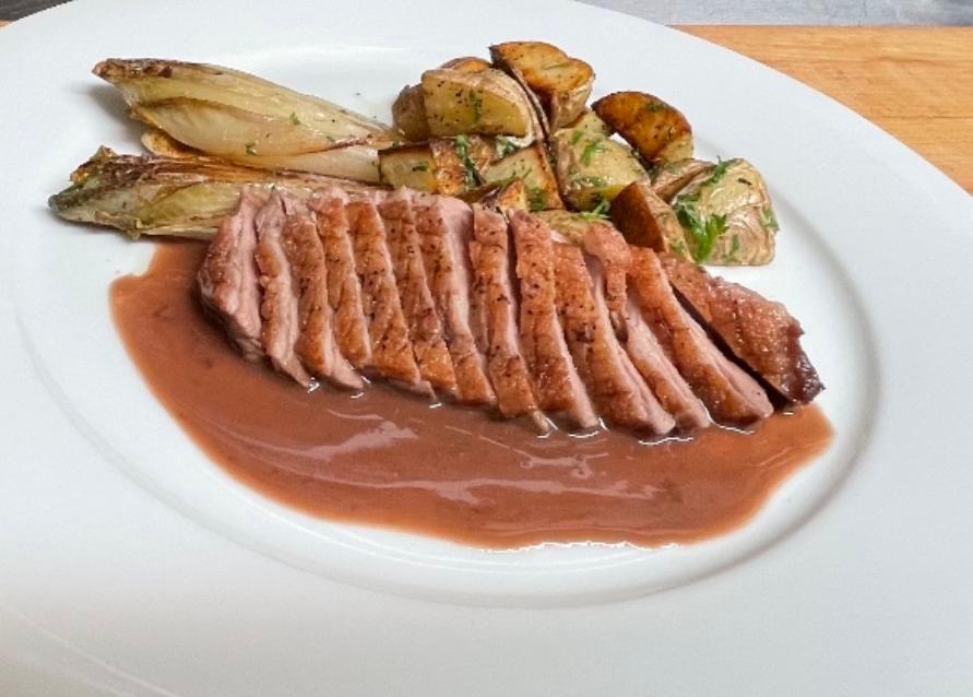 MAGRET DE CANARD/SEARED DUCK BREAST · Served with roasted fingerling potatoes, endive-gratinee and red wine butter sauce 