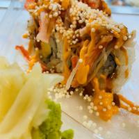 27. Dragon Spicy Crab · 8 pieces. Avocado and cucumber inside. On top spicy crab, spicy mayo, teriyaki, and crunch. 