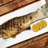 Whole Branzino Fish · Grilled Whole Fish topped with Homemade Dressing, Pita Bread and your choice of two side ord...