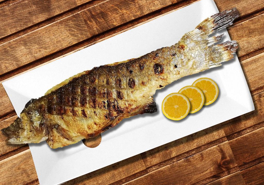 Whole Branzino Fish · Grilled Whole Fish topped with Homemade Dressing, Pita Bread and your choice of two side orders.
