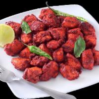 Chicken 65 · Boneless chicken prepared and blended spices is sauteed in a spicy yogurt sauce.