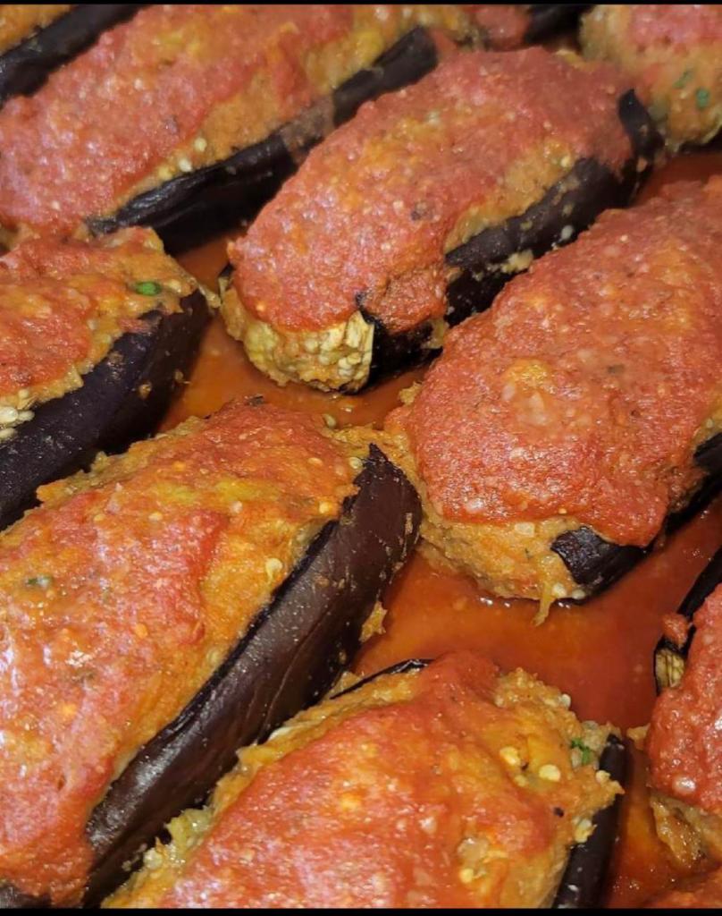 Stuffed Eggplant  · Eggplant stuffed with cheese, stuffing mix, topped with tomato sauce.