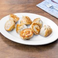 Fried Beef Momo Dumpling · 8 pieces. Steamed dumpling with beef filing which is pan fried after steaming.