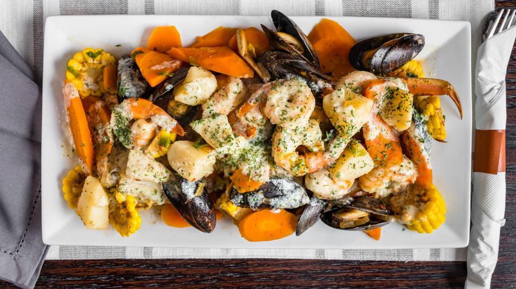 Breezes seafood platter · corn, carrots, potatoes, crab leg, lobster tail, shrimp, scallops and muscles