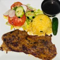 32. Carne Asada · Grilled beef served with rice, beans, salad and tortilla.