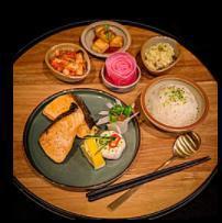 Salmon Bento · Served with rice, side dishes and salad.