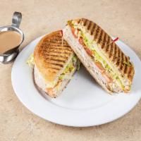 Tacchino Panini · Turkey, lettuce, tomatoes and provolone cheese. Made with homemade rosemary focaccia bread a...