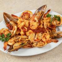 Zuppa Di Pesce · Mussels, clams, shrimp and calamari. Served with your choice of pasta; includes salad and ga...