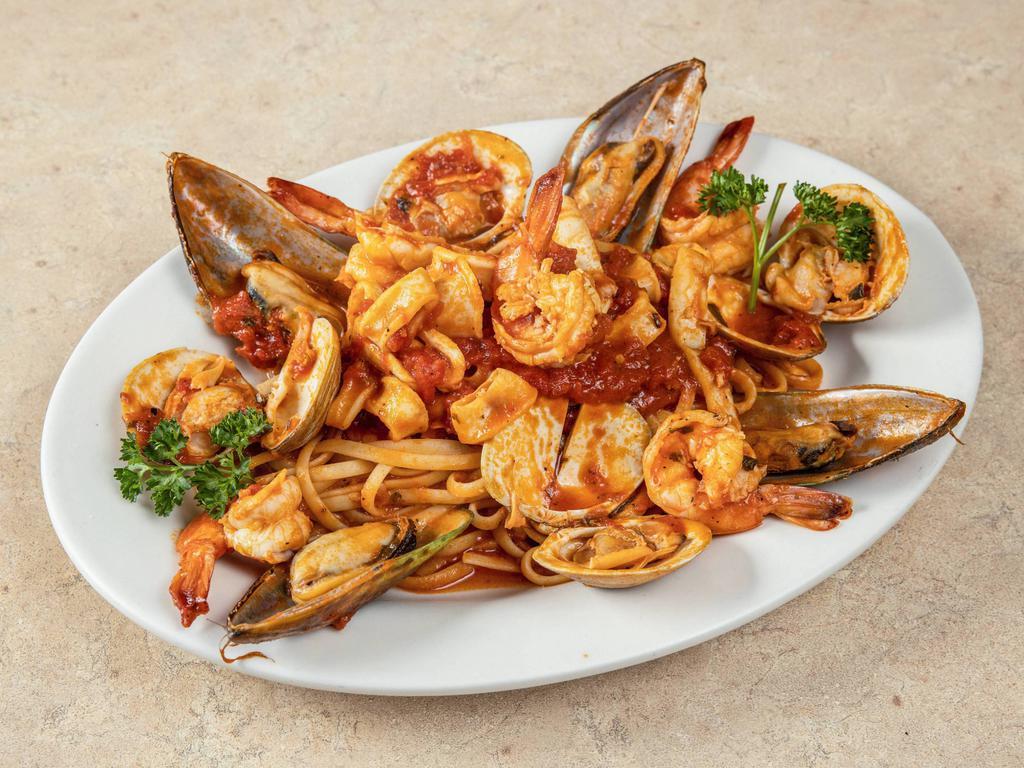 Zuppa Di Pesce · Mussels, clams, shrimp and calamari. Served with your choice of pasta; includes salad and garlic bread.
