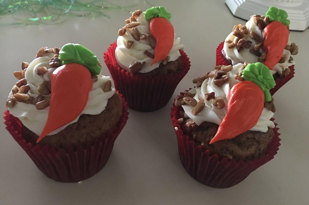 Carrot Cupcake · Carrot cupcake with cream cheese icing. Topped with pecans and an icing carrot

***DOES CONTAIN NUTS***