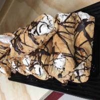 Canoli · Canolie Shell filled with our house specialty cream. Topped with chocolate drizzle.