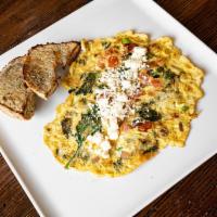 Egyptian Omelette · Eggs, green onion, spinach, tomato, and feta cheese served with bagel toast.