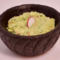 Guacamole · Traditional avocado dip with lime, cilantro, onions and chiles. Served with chips and salsa.