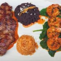 Mar Y Tierra · Grilled Jumbo shrimp sauteed in garlic, butter and lime, accompanied by a rib eye steak serv...