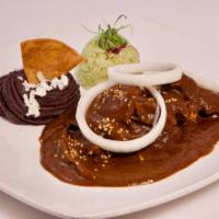 Mole Poblano · A potpourri of hot chiles, nuts, herbs, bread and roasted tomato with hints of chocolate, se...