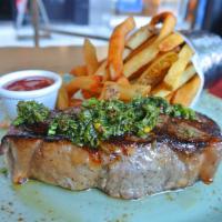 12 oz. NY Strip Steak Frites · Green chimichurri sauce, hand-cut fries, smoked jalapeno ketchup.
