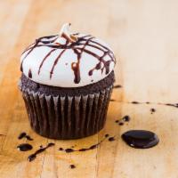 Devil Dog Cupcake · Rich chocolate cake with a whipped meringue frosting and chocolate drizzle.